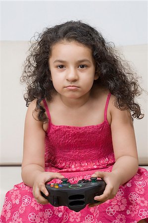 simsearch:6108-06905230,k - Portrait of a girl playing a video game Stock Photo - Premium Royalty-Free, Code: 630-03481222