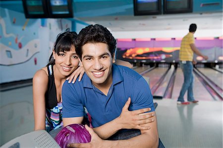 solid - Portrait of a young couple with a bowling ball in a bowling alley Stock Photo - Premium Royalty-Free, Code: 630-03481674