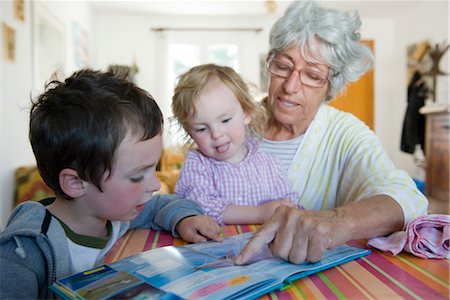 Grandmother reading book with young grandchildren Stock Photo - Premium Royalty-Free, Code: 632-05401085