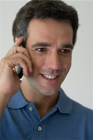simsearch:632-05400935,k - Man using cell phone, smiling Stock Photo - Premium Royalty-Free, Code: 632-05554092