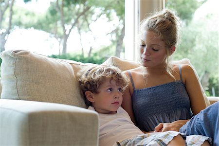 Mother and young son sitting together on sofa Stock Photo - Premium Royalty-Free, Code: 632-05554138