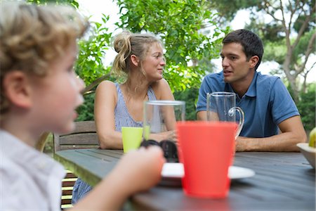 picnicking - Family relaxing together at table outdoors Stock Photo - Premium Royalty-Free, Code: 632-05553644