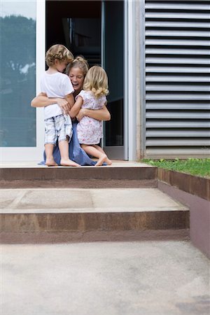 Mother embracing two young children outdoors Stock Photo - Premium Royalty-Free, Code: 632-05553899