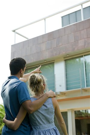 Couple standing together, looking at exterior of house Stock Photo - Premium Royalty-Free, Code: 632-05553933