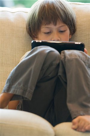 Boy using digital tablet Stock Photo - Premium Royalty-Free, Code: 632-05604162