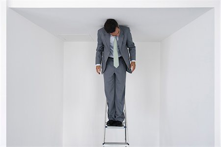Executive standing on stepladder Stock Photo - Premium Royalty-Free, Code: 632-05604172