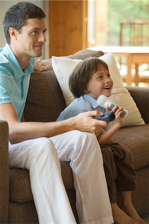entertainment and game - Father and son playing video game together Stock Photo - Premium Royalty-Free, Code: 632-05604216