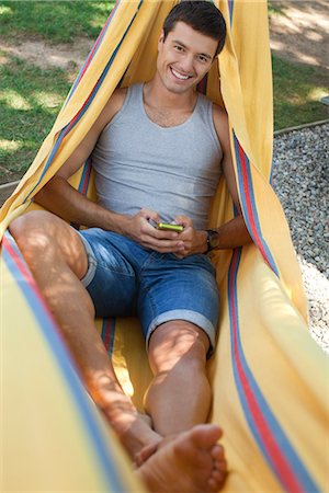 Man relaxing in hammock, portrait Stock Photo - Premium Royalty-Free, Code: 632-05604268