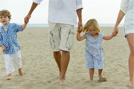 simsearch:632-03848361,k - Family walking hand in hand at the beach, cropped Stock Photo - Premium Royalty-Free, Code: 632-05604406