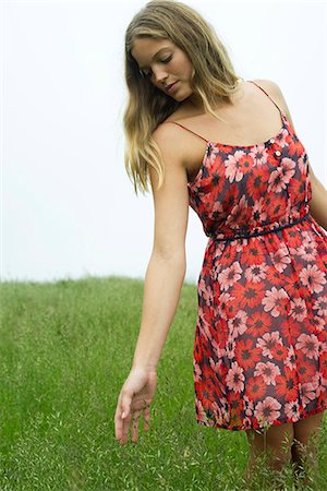 Young woman touching tall grass Stock Photo - Premium Royalty-Free, Code: 632-05604477