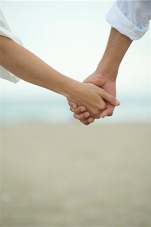 Couple holding hands outdoors, cropped Stock Photo - Premium Royalty-Free, Code: 632-05603991