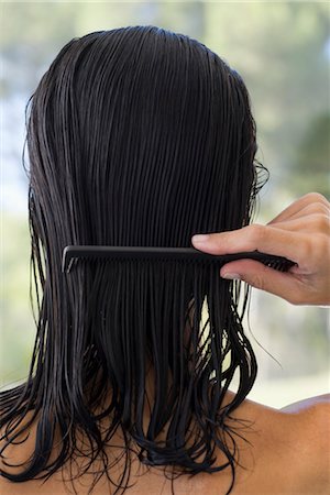 Woman combing hair, rear view Stock Photo - Premium Royalty-Free, Code: 632-05759568