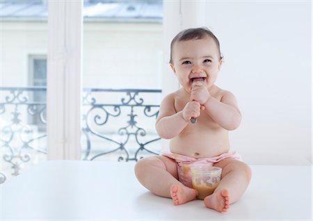 Infant eating with spoon, portrait Stock Photo - Premium Royalty-Free, Code: 632-05759577