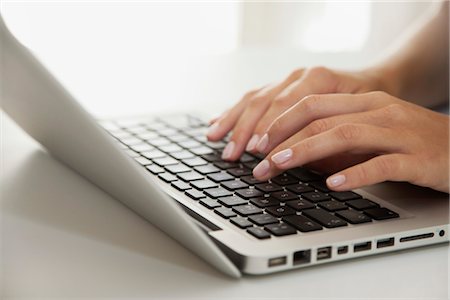 Woman's hands typing on laptop computer Stock Photo - Premium Royalty-Free, Code: 632-05760299
