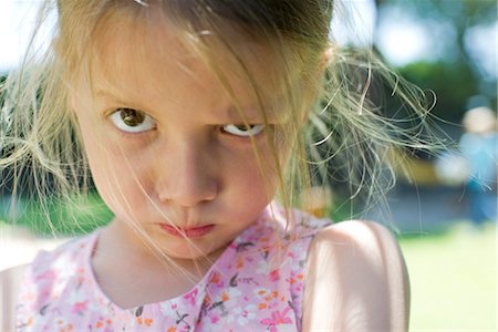 sulky tantrum - Little girl staring at camera with lips pursed Stock Photo - Premium Royalty-Free, Code: 632-05760417
