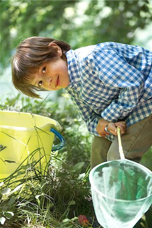simsearch:633-05401710,k - Boy leaning over bucket with fishing net in hands Stock Photo - Premium Royalty-Free, Code: 632-05760444
