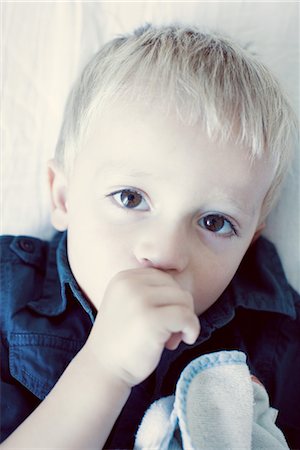Little boy sucking his thumb, portrait Stock Photo - Premium Royalty-Free, Code: 632-05760460