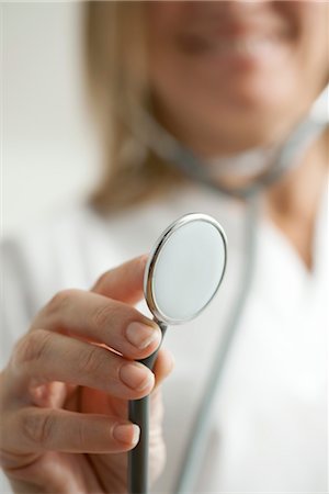 Doctor holding out stethoscope, cropped Stock Photo - Premium Royalty-Free, Code: 632-05760475