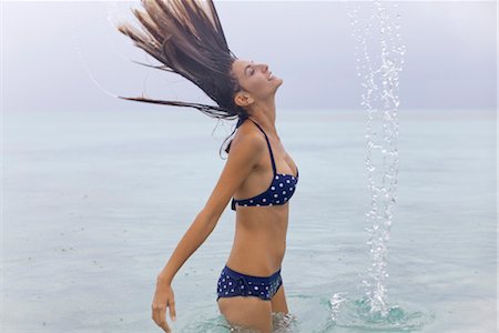 simsearch:632-05991893,k - Woman tossing wet hair in water Stock Photo - Premium Royalty-Free, Code: 632-05760489