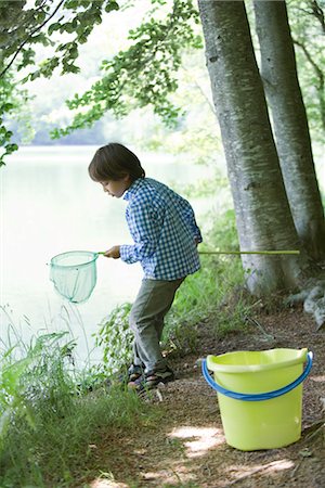 simsearch:633-05401710,k - Boy catching tadpoles at water's edge Stock Photo - Premium Royalty-Free, Code: 632-05760607