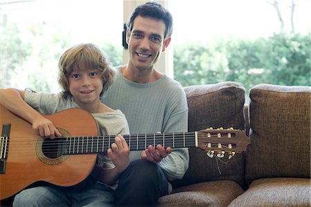 father teaching son - Father teaching son how to play guitar Stock Photo - Premium Royalty-Free, Code: 632-05760676