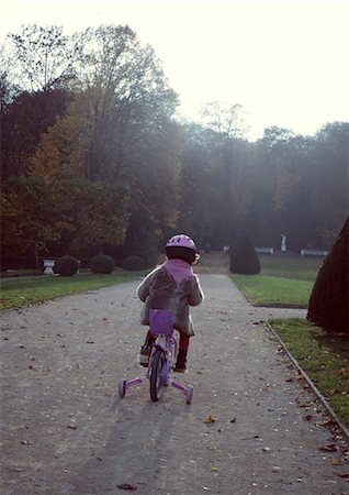 pedal - Little girl riding bicycle, rear view Stock Photo - Premium Royalty-Free, Code: 632-05760694