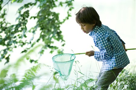 simsearch:633-05401710,k - Boy catching tadpoles at water's edge Stock Photo - Premium Royalty-Free, Code: 632-05760698