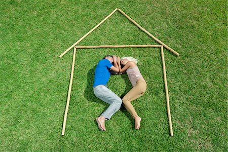 stick man - Couple lying on grass within outline of house, high angle view Stock Photo - Premium Royalty-Free, Code: 632-05816184