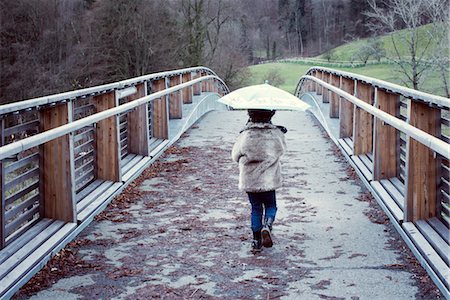 rear view little girl - Girl walking on bridge with umbrella, rear view Stock Photo - Premium Royalty-Free, Code: 632-05816439