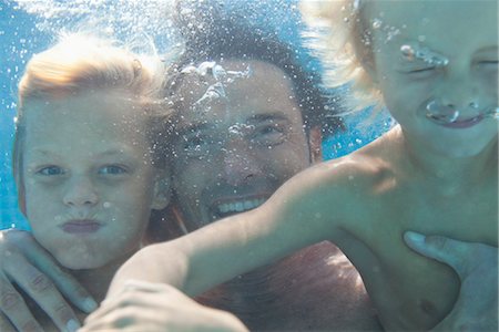 Father and sons swimming underwater Stock Photo - Premium Royalty-Free, Code: 632-05816446