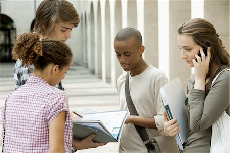 University students discussing schoolwork on campus Stock Photo - Premium Royalty-Free, Code: 632-05816451