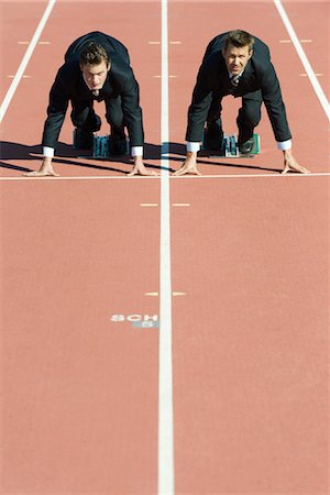 race starting line - Businessmen crouched in starting position on running track Stock Photo - Premium Royalty-Free, Code: 632-05816495