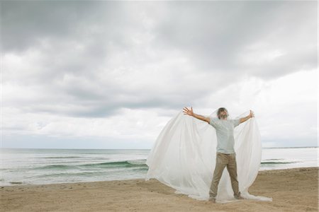 Man with arms outstretched trapped in plastic Stock Photo - Premium Royalty-Free, Code: 632-05817130