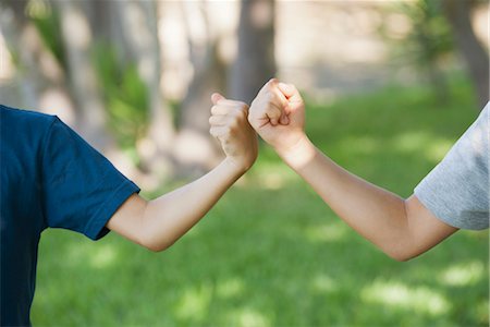 Young friends doing fist bump, cropped Stock Photo - Premium Royalty-Free, Code: 632-05845100