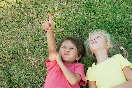 simsearch:614-06043612,k - Boy and girl lying on grass, looking up and pointing Stock Photo - Premium Royalty-Free, Code: 632-05845241