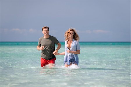 simsearch:632-05845211,k - Couple standing knee deep in water, holding hands Stock Photo - Premium Royalty-Free, Code: 632-05845251