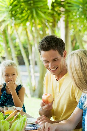 summer meal - Family having meal outdoors, focus on one man Stock Photo - Premium Royalty-Free, Code: 632-05845362