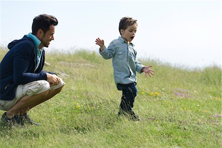 preschooler - Father and son playing in meadow Stock Photo - Premium Royalty-Free, Code: 632-05845492