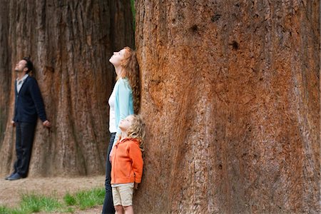 Mother and daughter leaning against tree trunk, breathing fresh air Stock Photo - Premium Royalty-Free, Code: 632-05845573