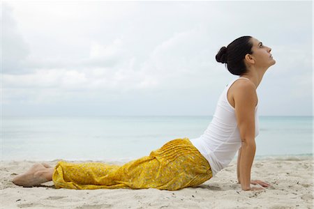 Mature woman in cobra pose on beach, side view Stock Photo - Premium Royalty-Free, Code: 632-05991219