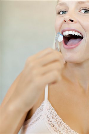 dental care woman - Young woman brushing teeth, cropped Stock Photo - Premium Royalty-Free, Code: 632-05991238