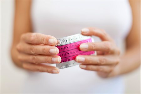 family planning - Woman's hand holding birth control pills, cropped Stock Photo - Premium Royalty-Free, Code: 632-05991253