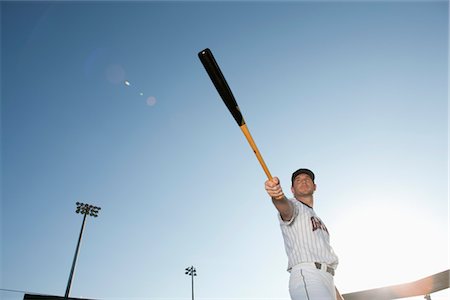 Baseball player holding out baseball bat Stock Photo - Premium Royalty-Free, Code: 632-05991688