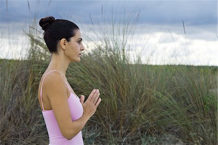 prayer position - Mature woman in prayer position outdoors, side view Stock Photo - Premium Royalty-Free, Code: 632-05991717