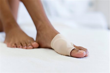 Woman's foot wrapped in brace for injured toe, low section Stock Photo - Premium Royalty-Free, Code: 632-05991915