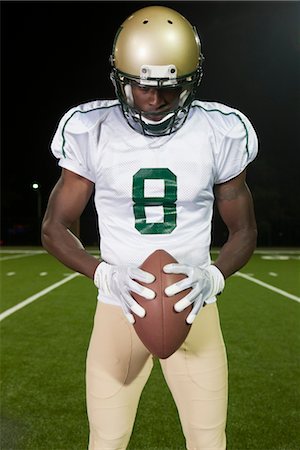 football player not soccer - Football player holding ball, portrait Stock Photo - Premium Royalty-Free, Code: 632-05992160