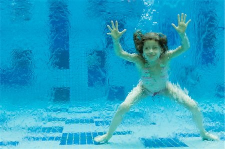 Girl swimming underwater in swimming pool Stock Photo - Premium Royalty-Free, Code: 632-06029785