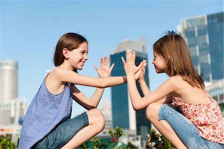 preteen girls - Girls playing pattycake Stock Photo - Premium Royalty-Free, Code: 632-06029789