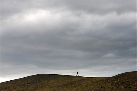 people walking in the distance - Iceland, person walking along barren hilltop Stock Photo - Premium Royalty-Free, Code: 632-06029934