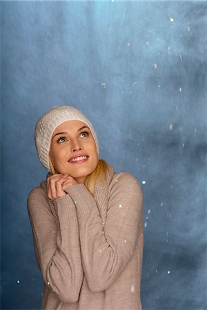 snowfall - Woman wearing knit hat in front of snowy background, portrait Stock Photo - Premium Royalty-Free, Code: 632-06118103